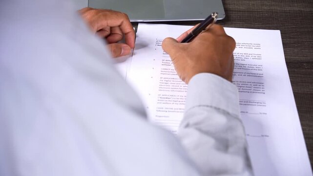 Man in White Shirt Completing Will Document