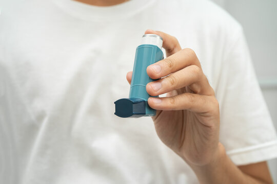 Asthma and chronic obstructive pulmonary disease COPD, Asian teenage using metered dose inhaler MDI.