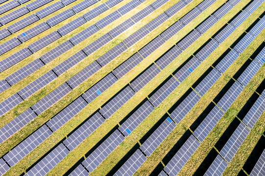 Helicopter view of rows of panels of solar power station