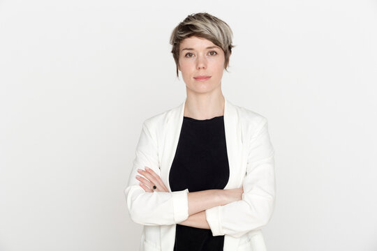 Portrait of woman with dyed short hair against white background