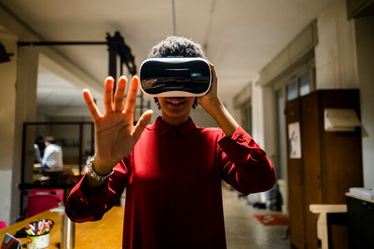 Woman wearing VR glasses in office