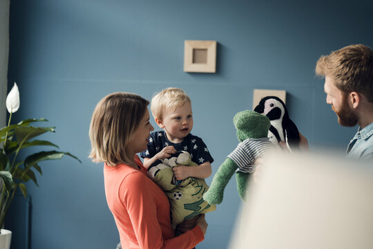 Happy family playing with their son at home
