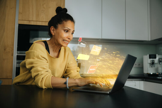 Worried woman using laptop with speech bubble icon at home