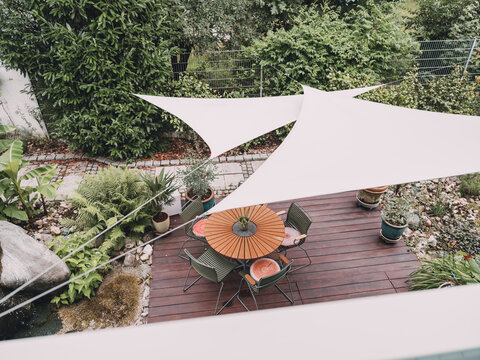High angle view of empty outdoor dining patio with sunshade