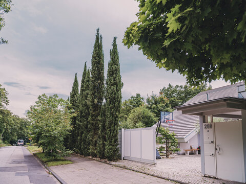 Modern villa entrance with rolling door and driveway outdoors