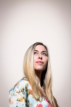 Portrait of model looking up indoors with copy space