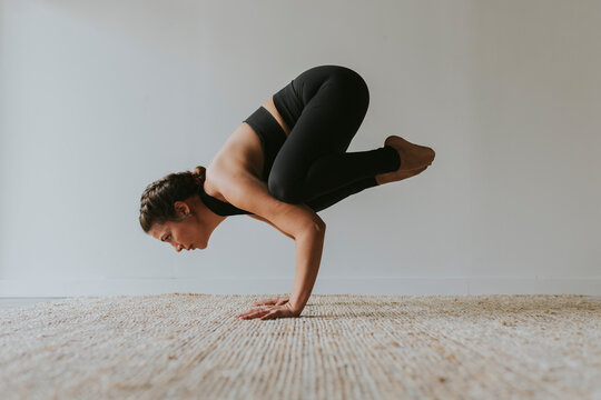 Yogi practicing Kakasana pose in health club