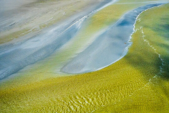 Aerial view of mudflat and sandbank at low tide in Normandy