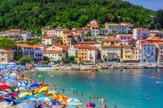 People enjoying at beach by Opatija town during summer