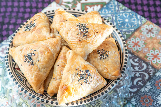 Traditional Asian food pies with sesame seeds on plate.