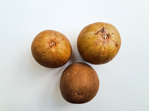 Top View of Three Fresh Sapodilla Fruits (Manilkara zapota) Isolated on White Background