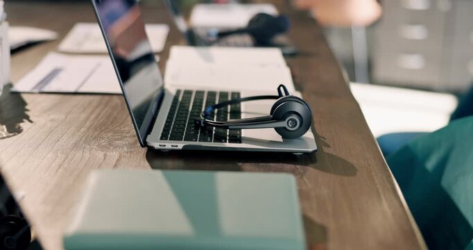 Headset, laptop and desk with paper in empty office for customer support, consulting and lead generation. Workplace, background and computer with mic for crm service, telemarketing and contact us