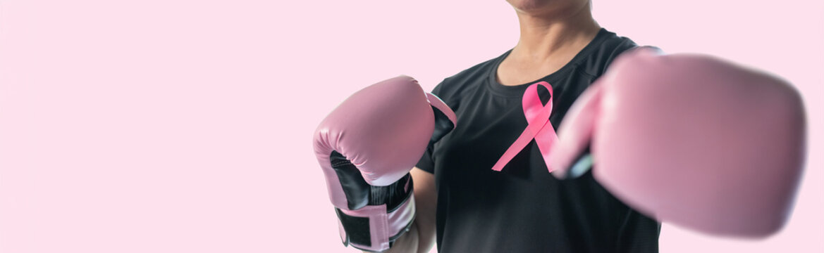 Breast cancer awareness pink ribbon for women health in October month, female patient fighting with tumor on pastel rose pink background