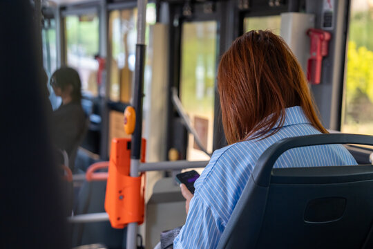 Passengers riding in public transport, seated and standing during a daily commute, representing urban mobility, shared travel, routine life, and city transportation systems.