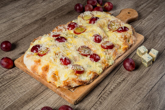 Fresh homemade pizza topped with melted cheese, tomato sauce, and flavorful ingredients, baked to a golden crust, showcasing delicious comfort food and traditional home cooking.