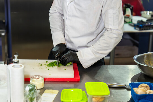 Professional chef cooking in a modern kitchen, preparing fresh ingredients with precision and skill, demonstrating culinary expertise, creativity, and high-quality food preparation techniques.