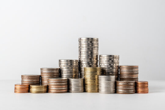 Stacks of Mixed Coins on White Background Representing Savings, Investment and Financial Growth