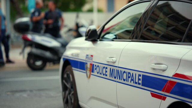 French municipal police cruiser parked, showing vehicle details and security emblem. Law enforcement maintaining order