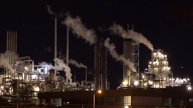 HVC Waste-to-Energy Plant in Dordrecht, Netherlands, Operating at Night with Emissions Visible from Chimneys.