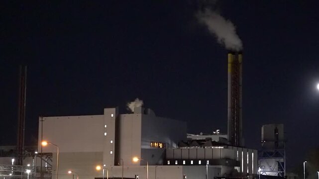 HVC Waste-to-Energy Plant in Dordrecht, Netherlands, Operating at Night with Emissions Visible from Chimneys.