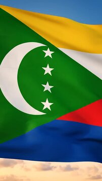 The national flag of Comoros waving against a blue sky