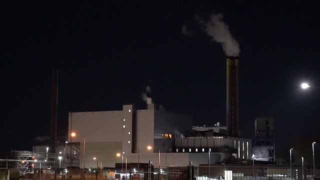 HVC Waste-to-Energy Plant in Dordrecht, Netherlands, Operating at Night with Emissions Visible from Chimneys.