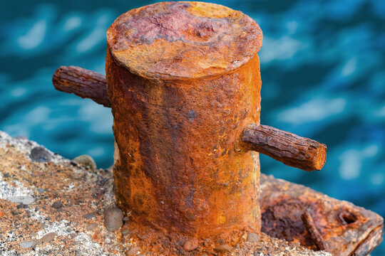 Old, rusting bollard at the harbor