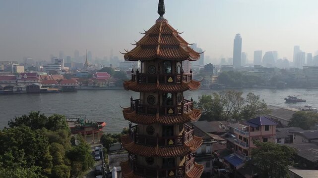Aerial around view of Wat Che Chin Koh temple tower, Bangkok, Thailand, 4k
