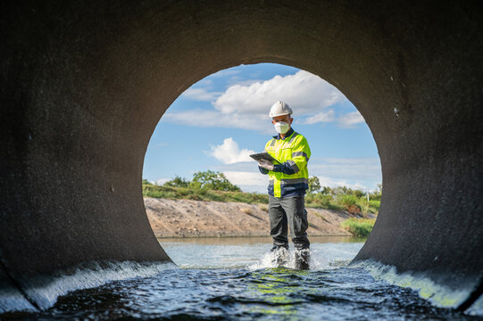 Professional Engineer Inspecting Drainage Water Quality for Environmental Infrastructure