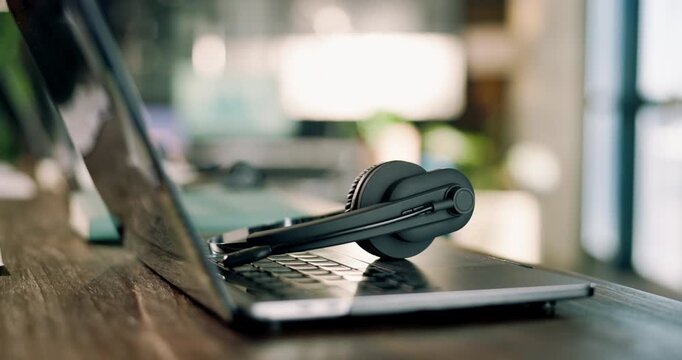 Headset, empty and laptop in call center office for customer support, online advice and lead generation. Workplace, background and computer with mic for crm service, telemarketing and contact us