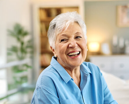 Portrait of a happy senior elderly woman posing at home