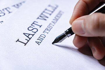Close Up Hand Writing Last Will and Testament Estate Planning Document