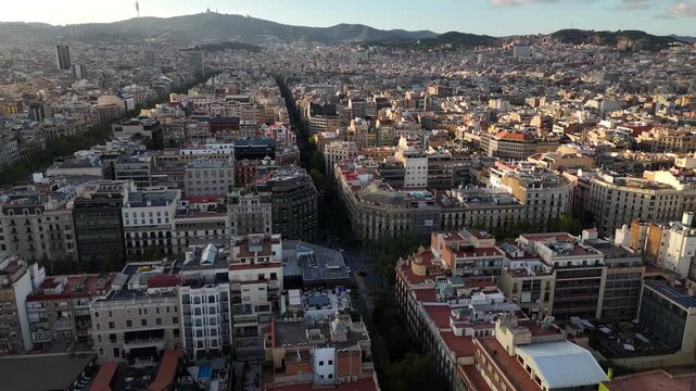 Drone Shot of Barcelona Spain Downtown Neighborhoods, Buildings and Streets on Golden Hour Sunlight