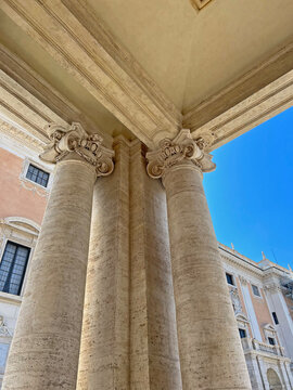 Classic Roman architecture with travertine columns and ornate Baroque details. Capturing classical architecture, heritage, and tourism in Rome.