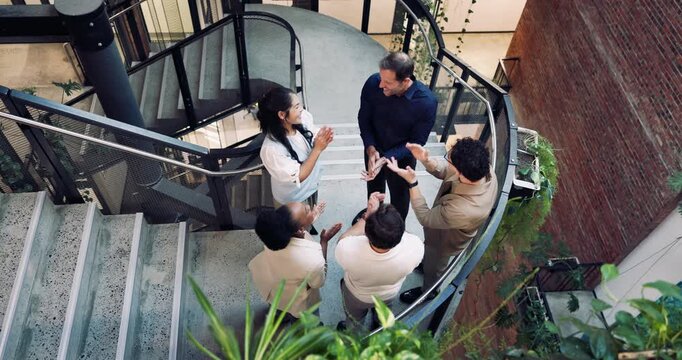 Business people, team building and stack hands at office for mission, goal celebration or solidarity. Group, above and clapping for success by stairs, cohesion or collaboration with achievement