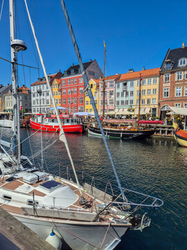 Sailboat at the famous Nyhavn Harbor (or New Port) with colorful buildings, Copenhagen cityscape, Denmark