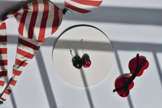Hot girl summer starter kit: heart-shaped sunglasses, cherries and a swimsuit