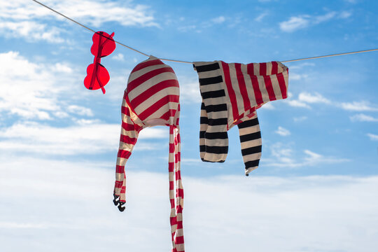 Bathing suit and heart-shaped sunglasses hanging on clothesline