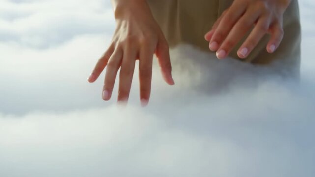 Manicured hands exploring dense low fog under soft daylight, neutral clothing, gentle curved pose and wide panoramic composition with calm minimal mood, with hand, finger, manicure, nail detail