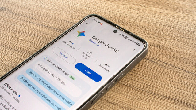 KULIM,MALAYSIA - JULY 13TH,2026 : A close-up shot of an android smartphone placed on a wooden surface showing the Google Gemini AI application page inside the Google Play Store.