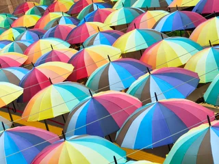 High angle view of a colorful umbrella street art installation hanging overhead © Özgür Güvenç