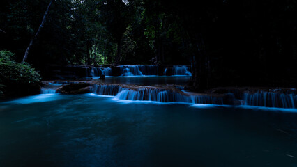 Cascading Waterfall Flows Through A Lush Forest At Huai Mae Khamin Waterfall In Kanchanaburi Thailand © SHUTTER DIN