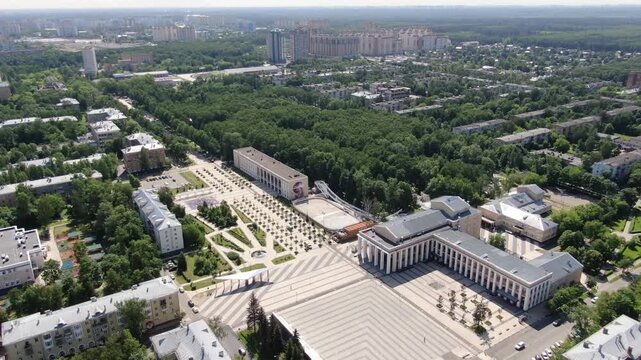 Drone descending forward above Korolev urban square