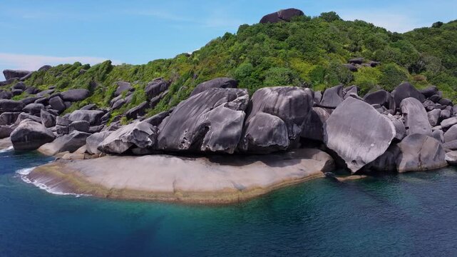 A beautiful 4K drone shot showcasing the massive granite rock formations and turquoise waters of Koh Ba Ngu Similan Island in Thailand.