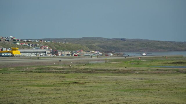 Long-lens ground view showing a Canadian North commercial regional airliner spooling its engines at the threshold of the main runway.