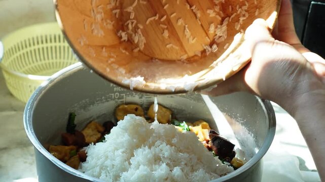 4K Close Up of Adding Washed Rice to Rice Cooker for Homemade Vegetarian Cooking