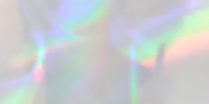 Holographic silver texture background with vibrant rainbow neon light reflections. Iridescent metallic foil backdrop ideal for trendy futuristic and colorful modern graphic design