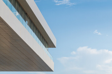 Modern Mediterranean architecture. White building cornice with glass facade. Blue sky and copy space © Inspiraciones