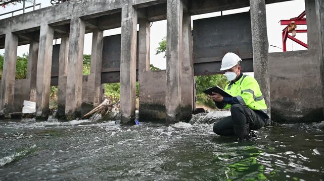 Engineer Inspecting Water Gate Structure for Irrigation and Flood Control Infrastructure