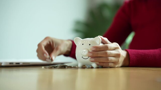 Person stacking coins beside a piggy bank, illustrating personal savings, budgeting, financial planning, and smart money management.